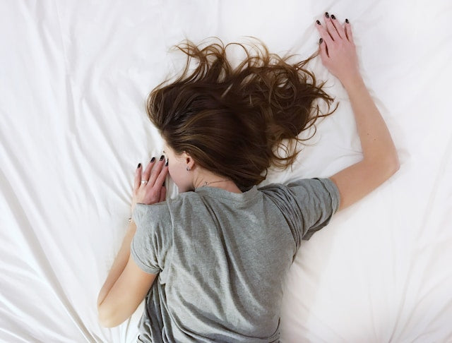 woman laying on her mattress bed