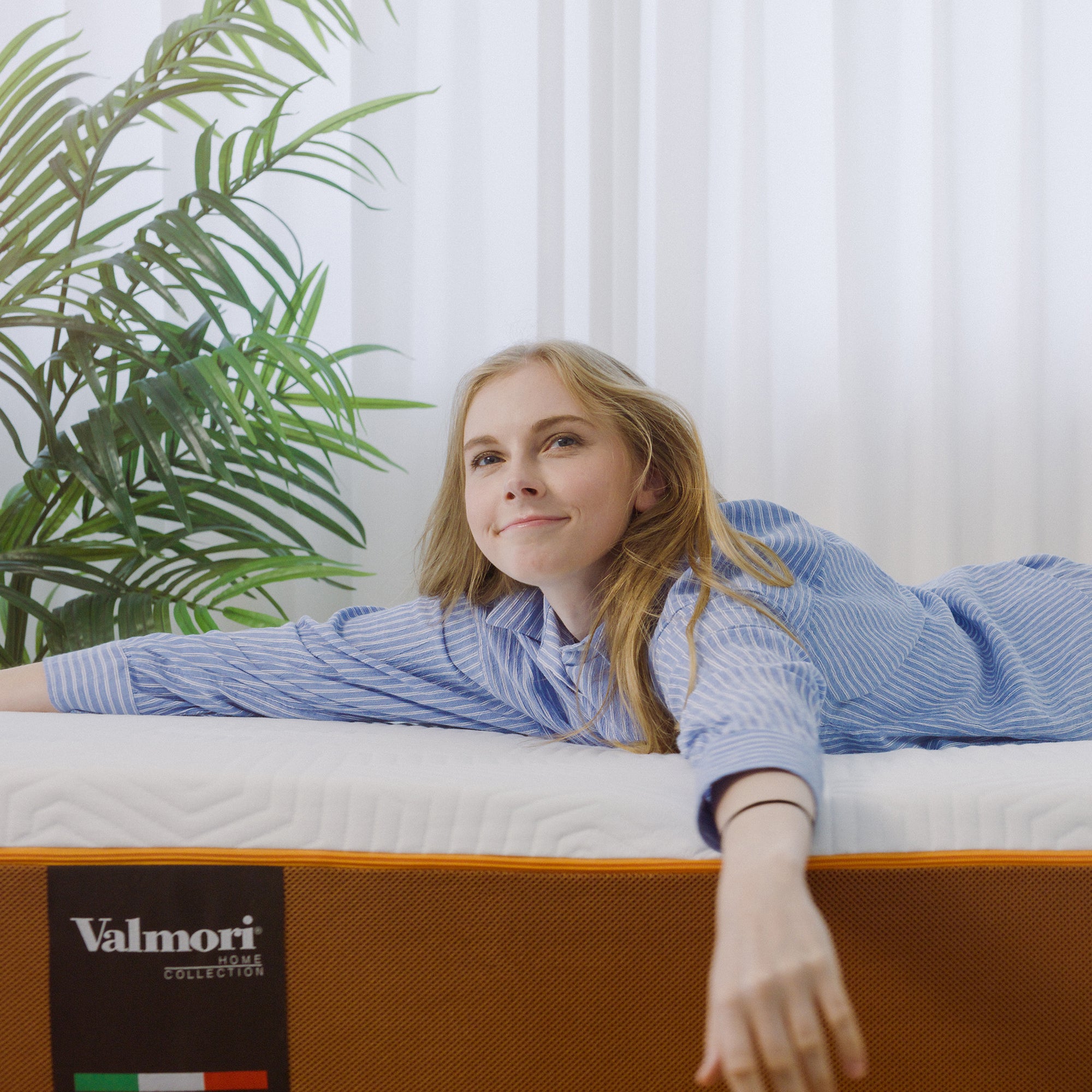 A woman lying on a Valmori Medium S-Shape Foam Mattress Ⅱ